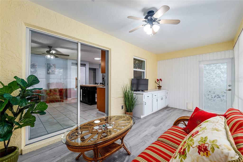 9770 Southwest 97th Place Ocala, FL 34481 - Photo 48 of 64 a living room with furniture and a chandelier