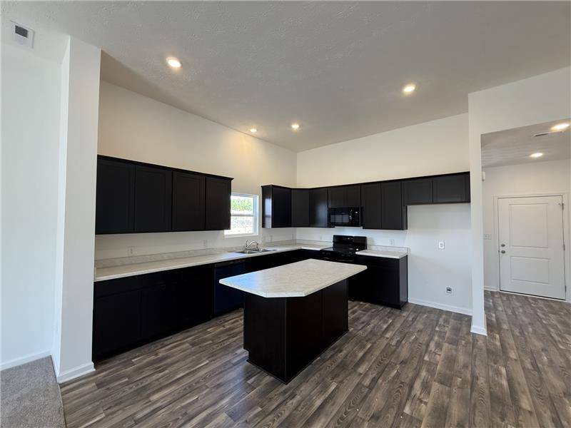 4001 Chakeres Avenue Springfield, OH 45505 - Photo 6 of 15 This kitchen features a central island, modern appliances, and ample cabinet space.