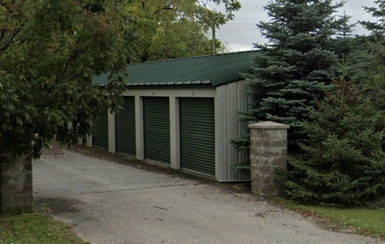 a backyard of a house with plants and trees