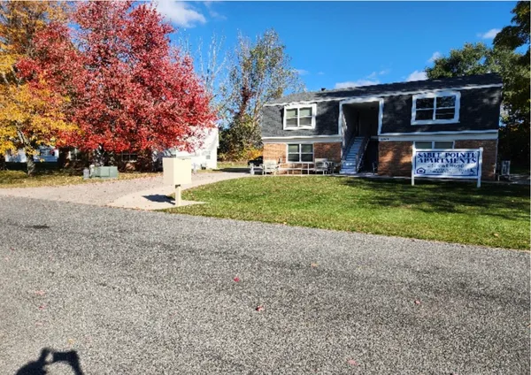 a front view of a house with a yard and a garage