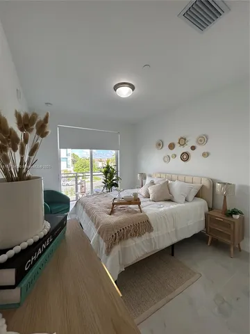 a bedroom with a bed and a window