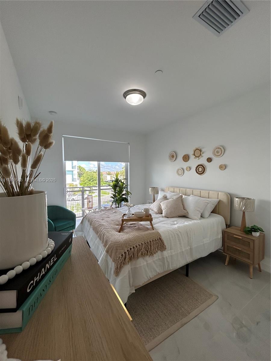 1010 Southwest 69th Avenue, Unit 104 Miami, FL 33144 - Photo 3 of 16 a bedroom with a bed and a window