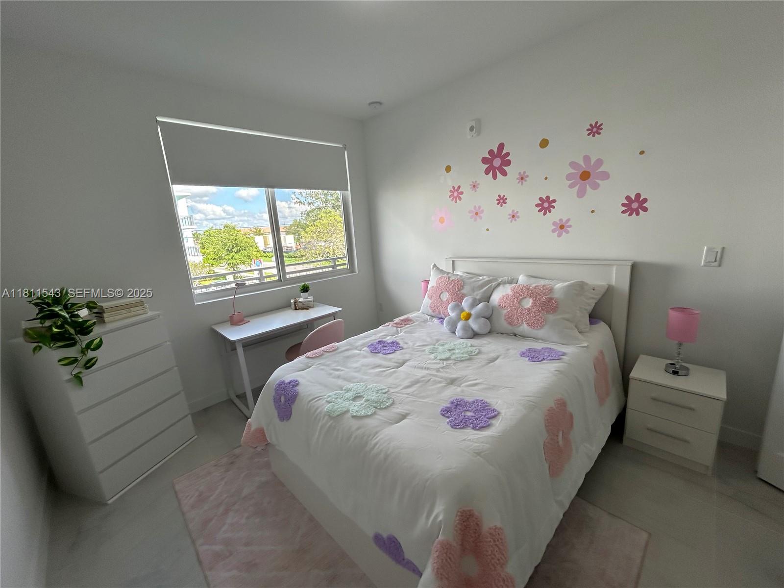 1010 Southwest 69th Avenue, Unit 104 Miami, FL 33144 - Photo 7 of 16 a bedroom with a bed and a window