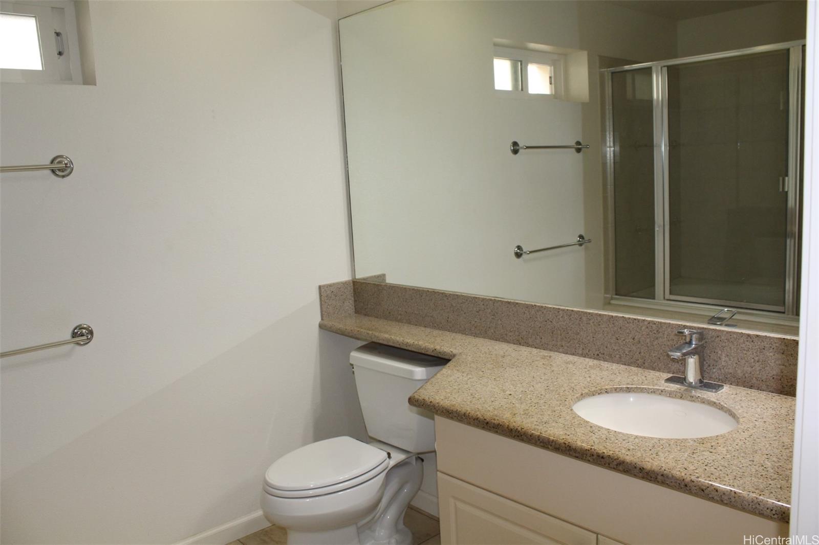 520 Lunalilo Home Road, Unit 7328 Honolulu, HI 96825 - Photo 13 of 22 a bathroom with a granite countertop sink toilet a mirror and shower