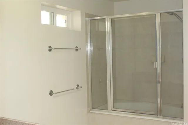a bathroom with a glass shower door