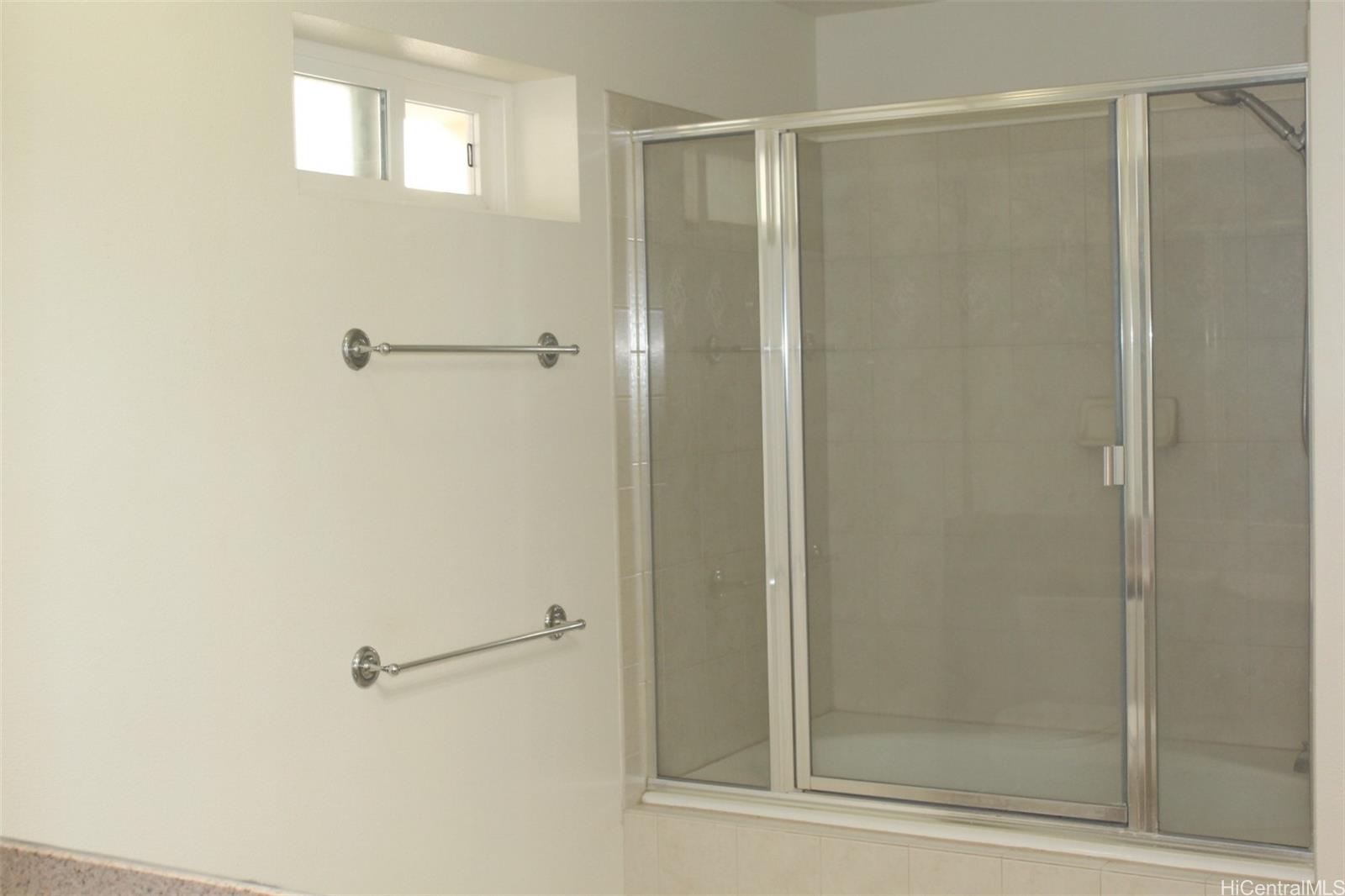 520 Lunalilo Home Road, Unit 7328 Honolulu, HI 96825 - Photo 14 of 22 a bathroom with a glass shower door