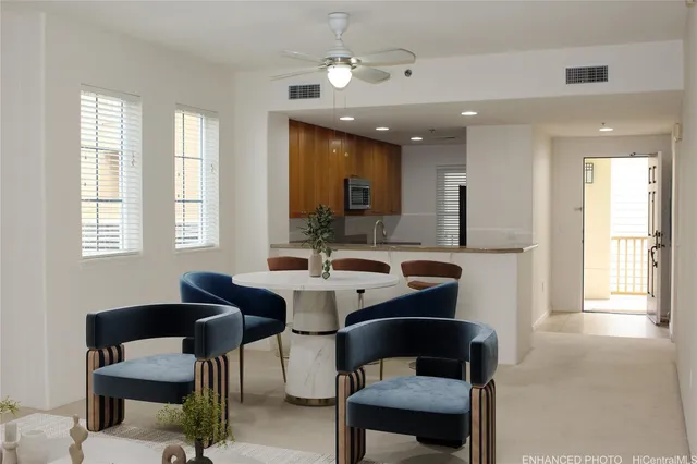 a view of a dining room with furniture and a chandelier