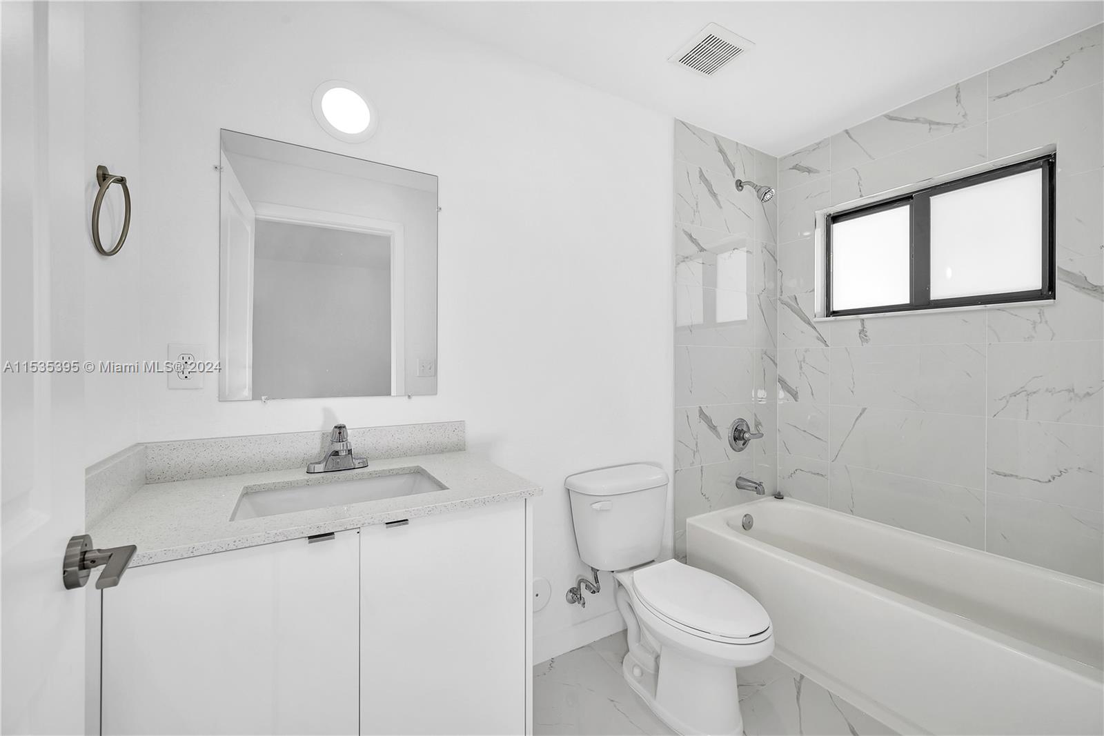 673 Northwest 14th Street, Unit 1 Florida City, FL 33034 - Photo 12 of 20 a bathroom with a sink toilet and shower