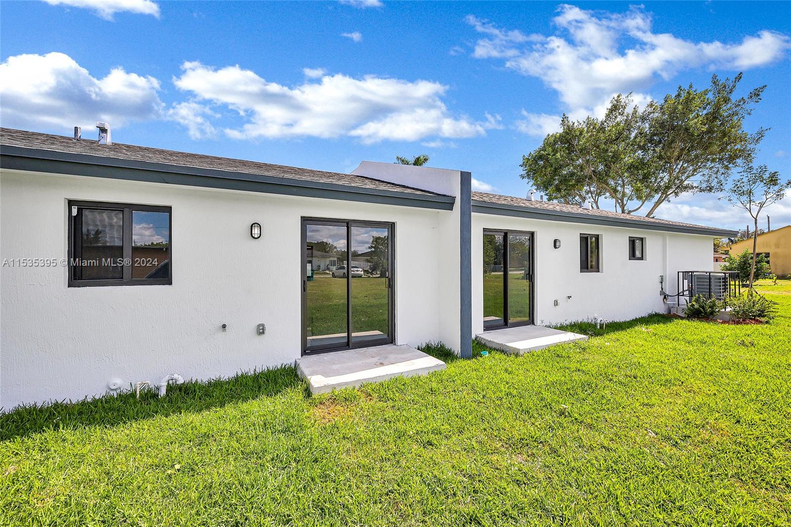 673 Northwest 14th Street, Unit 1 Florida City, FL 33034 - Photo 18 of 20 a view of a house with backyard and garden