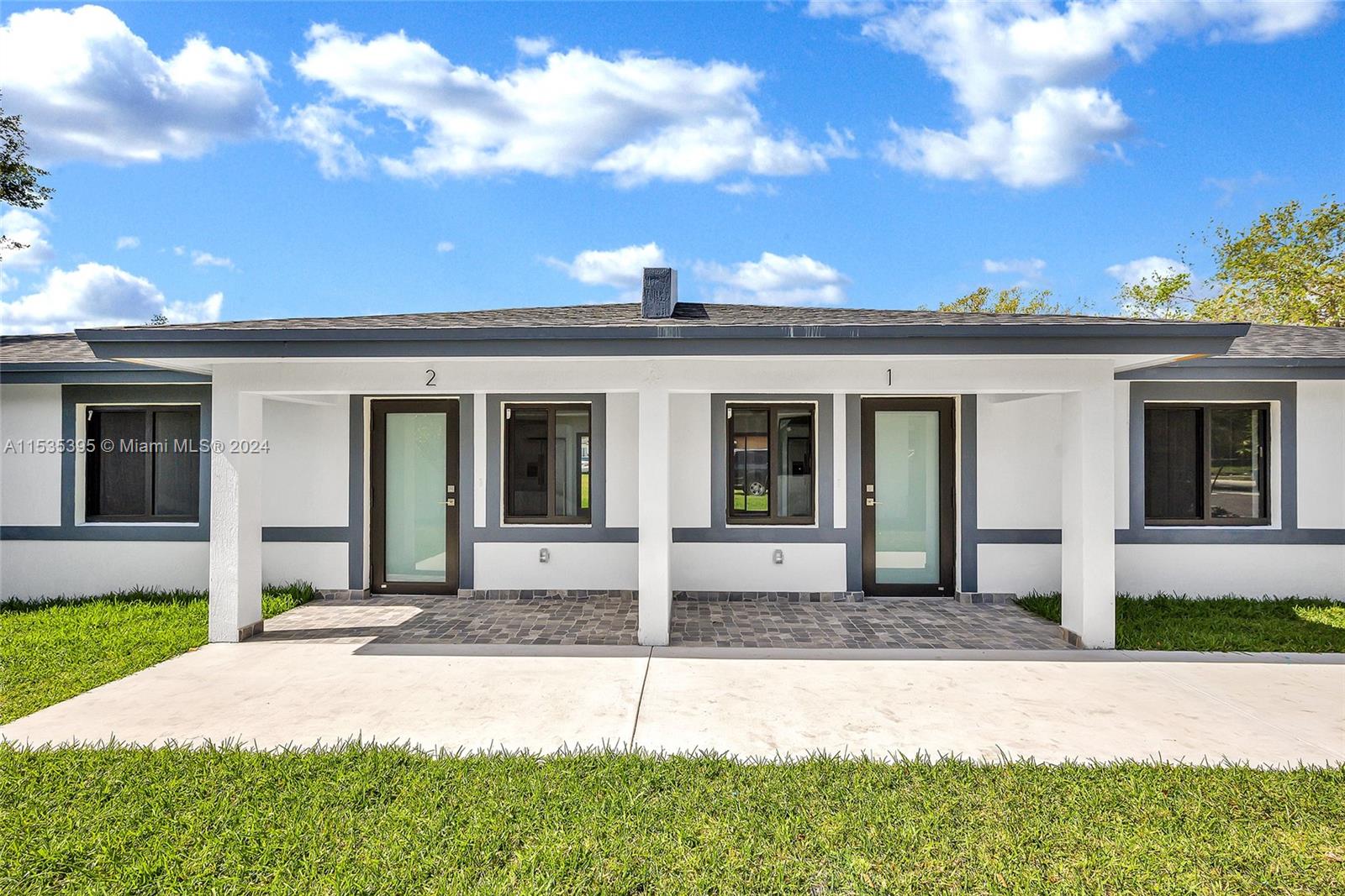 673 Northwest 14th Street, Unit 1 Florida City, FL 33034 - Photo 20 of 20 a front view of a house with a yard and garage