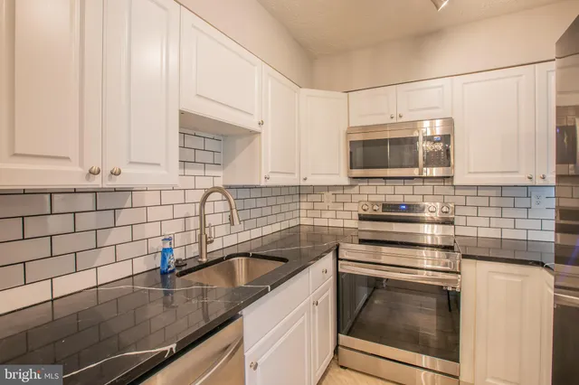 a spacious bathroom with a sink and a mirror