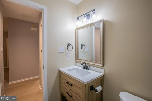 a bathroom with a toilet a sink and mirror