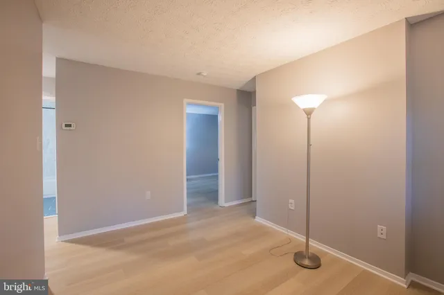 an empty room with a empty space and windows