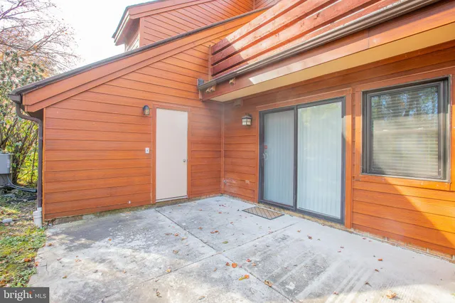 a living room with a fireplace and wooden floor
