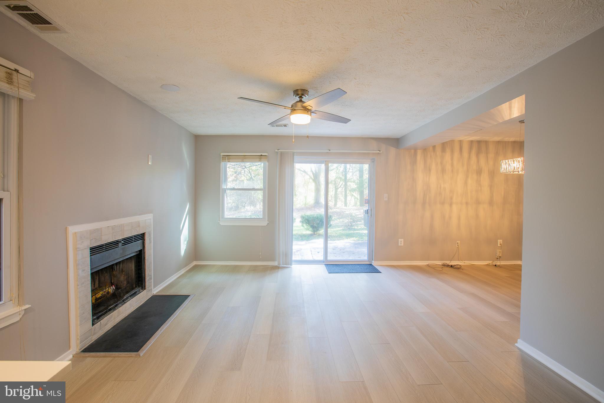 7537 Weather Worn Way, Unit A Columbia, MD 21046 - Photo 6 of 23 a view of an empty room with a fireplace and a window