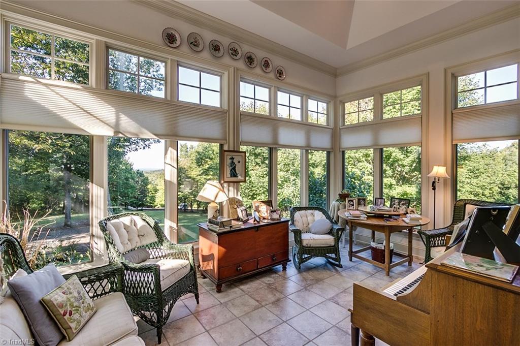 2172 Stone Bridge Road Asheboro, NC 27205 - Photo 8 of 30 The high vaulted ceiling and the picturesque view makes this sunroom very inviting.