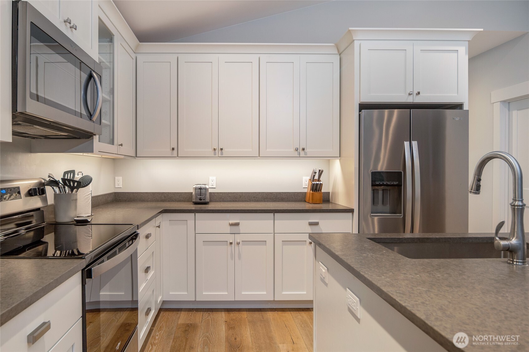 492 Finnegan Ridge, Unit 2 Friday Harbor, WA 98250 - Photo 11 of 29 a kitchen with stainless steel appliances granite countertop a sink stove and refrigerator