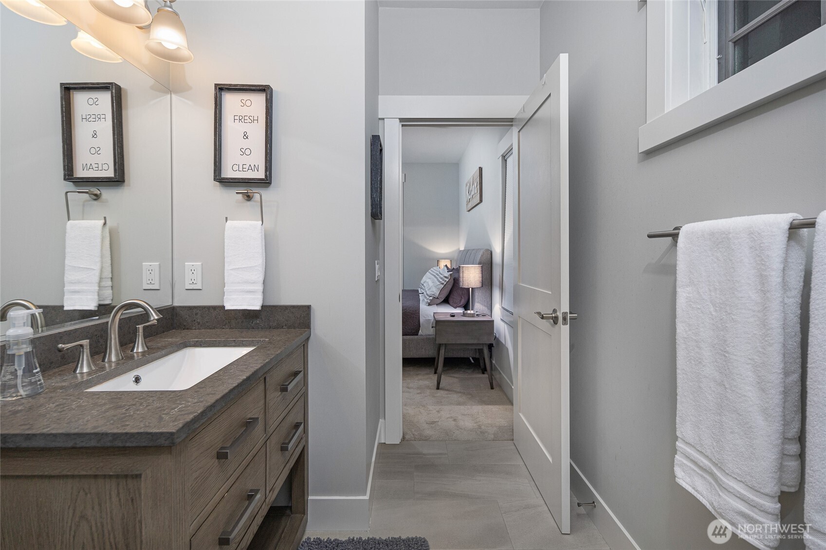 492 Finnegan Ridge, Unit 2 Friday Harbor, WA 98250 - Photo 18 of 29 a en suite bathroom with a granite countertop sink and a mirror