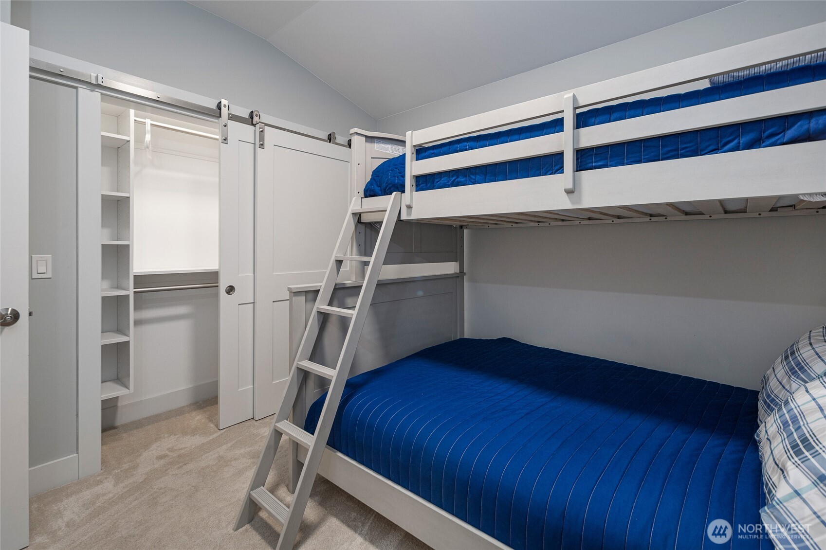 492 Finnegan Ridge, Unit 2 Friday Harbor, WA 98250 - Photo 20 of 29 a bedroom with a bed and a walk in closet