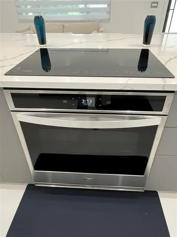 a view of an empty room with a window and a ceiling fan