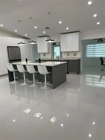 a large white kitchen with lots of counter space