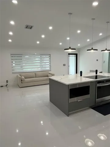 a large kitchen with a table and chairs