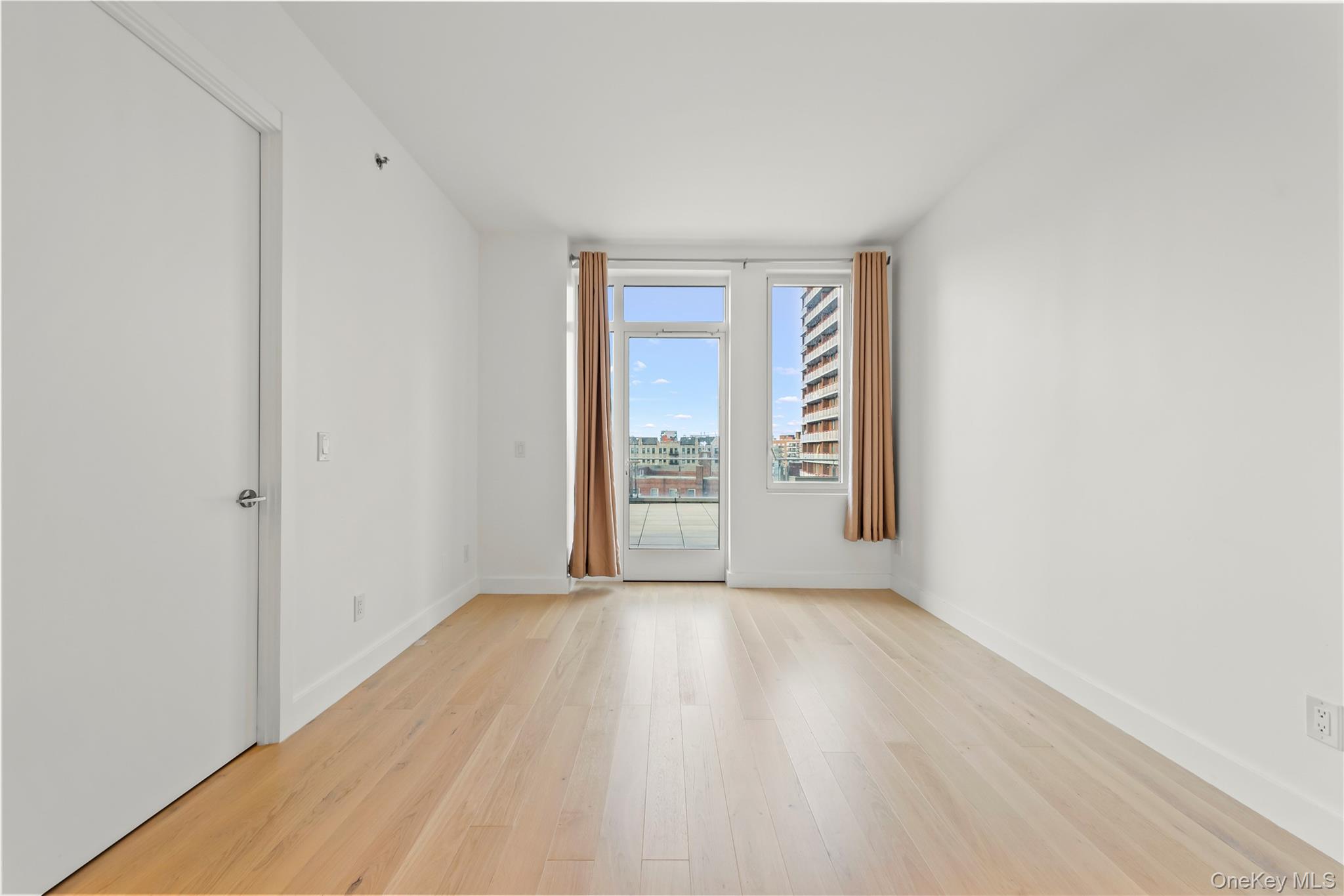 13618 Maple Avenue, Unit 5G Queens, NY 11355 - Photo 13 of 16 Unfurnished room with light wood-style flooring and a view of city