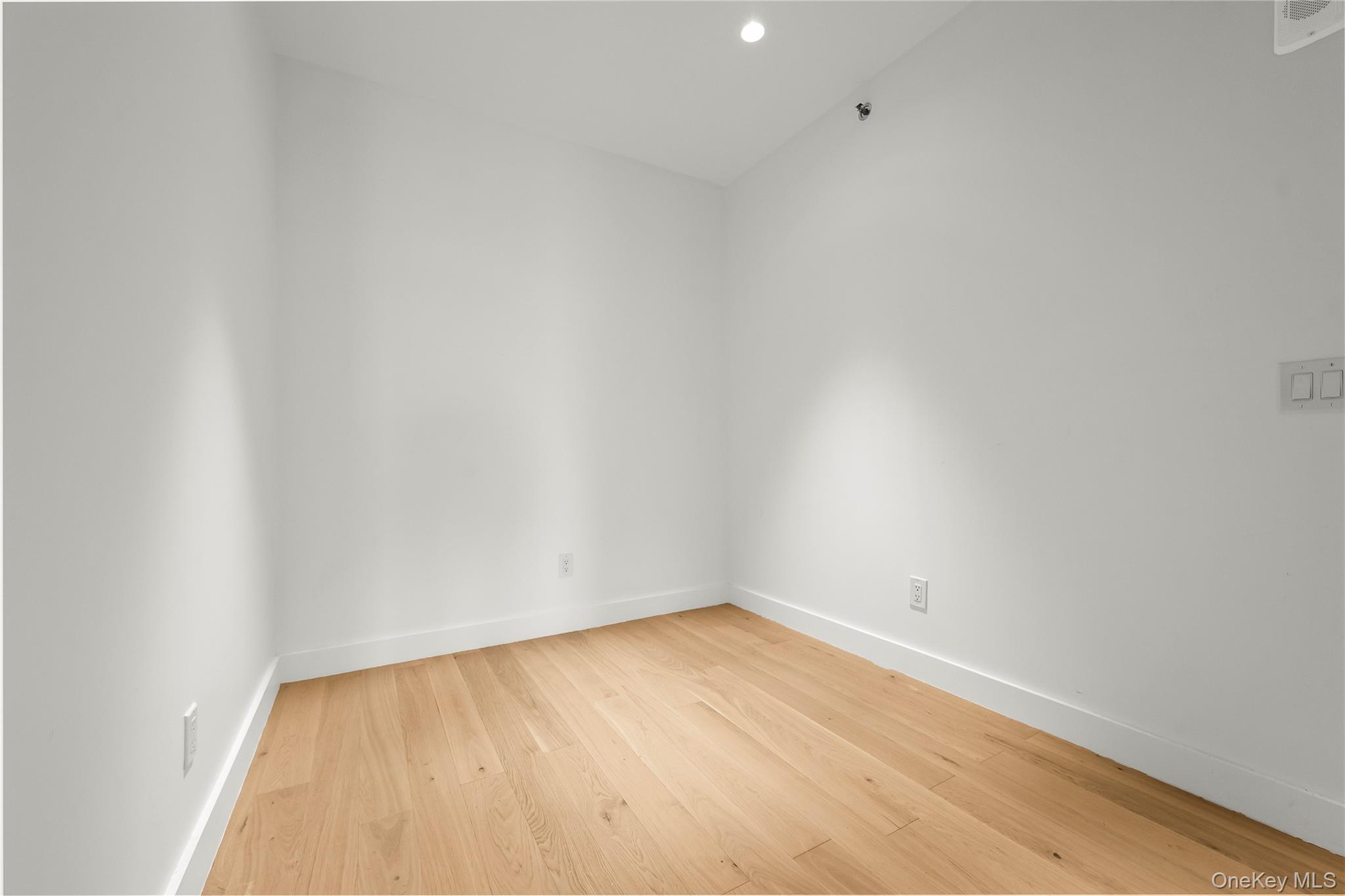 13618 Maple Avenue, Unit 5G Queens, NY 11355 - Photo 14 of 16 Empty room with light wood-style floors and recessed lighting