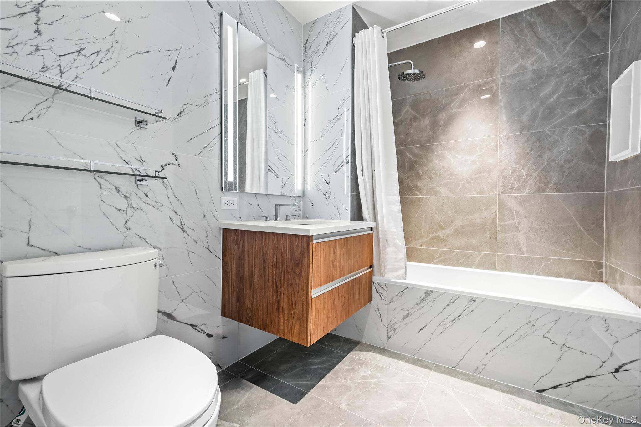 13618 Maple Avenue, Unit 5G Queens, NY 11355 - Photo 16 of 16 Bathroom with vanity, tiled shower / bath combo, light marble finish floors, and tile walls
