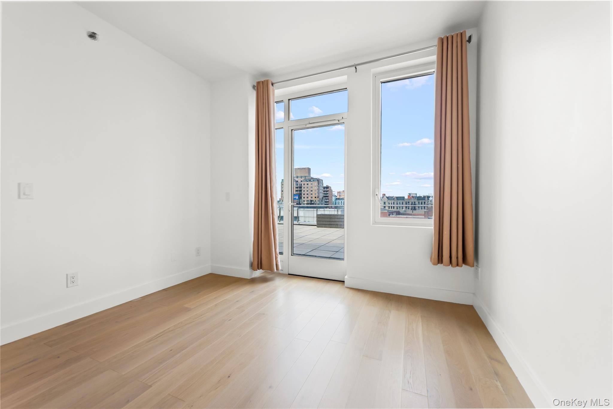 13618 Maple Avenue, Unit 5G Queens, NY 11355 - Photo 4 of 16 Unfurnished room featuring light wood-style floors and a view of city