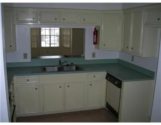 a kitchen with a cabinets and window