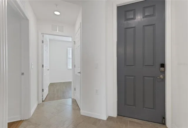 a view of a brick building with a yard and plants