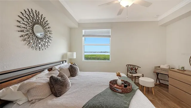 a view of a patio with table and chairs potted plants with wooden floor and floor to ceiling window