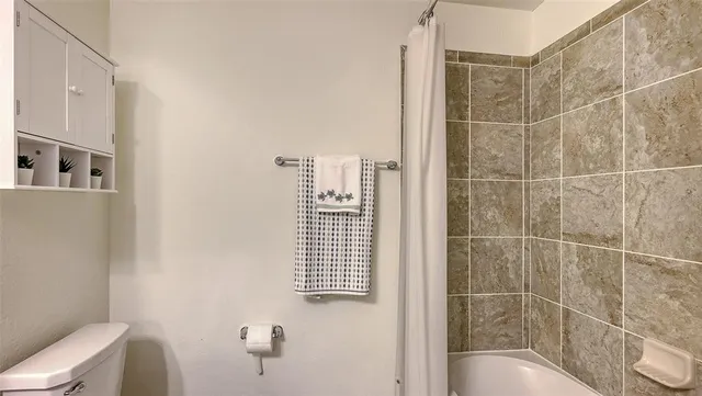 a aerial view of a house with a big yard and large trees