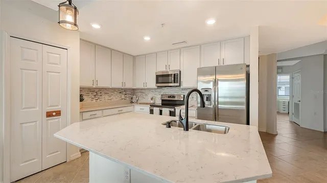 a living room with furniture a rug and white walls