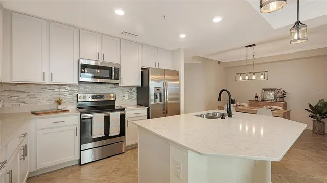 a bathroom with a granite countertop sink a toilet and a mirror