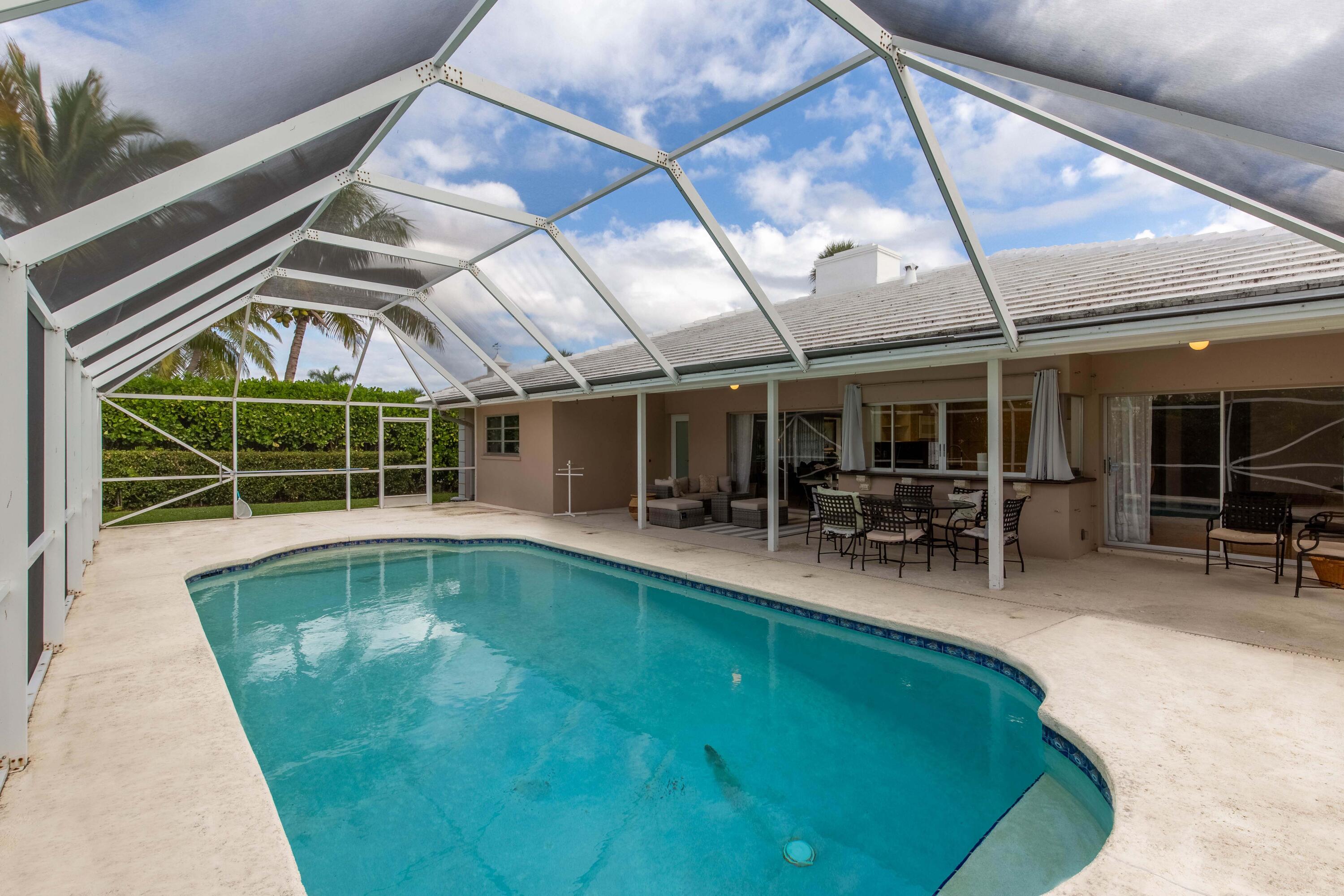 1323 Sugar Plum Drive Boca Raton, FL 33486 - Photo 20 of 28 a view of a swimming pool with a patio and a backyard