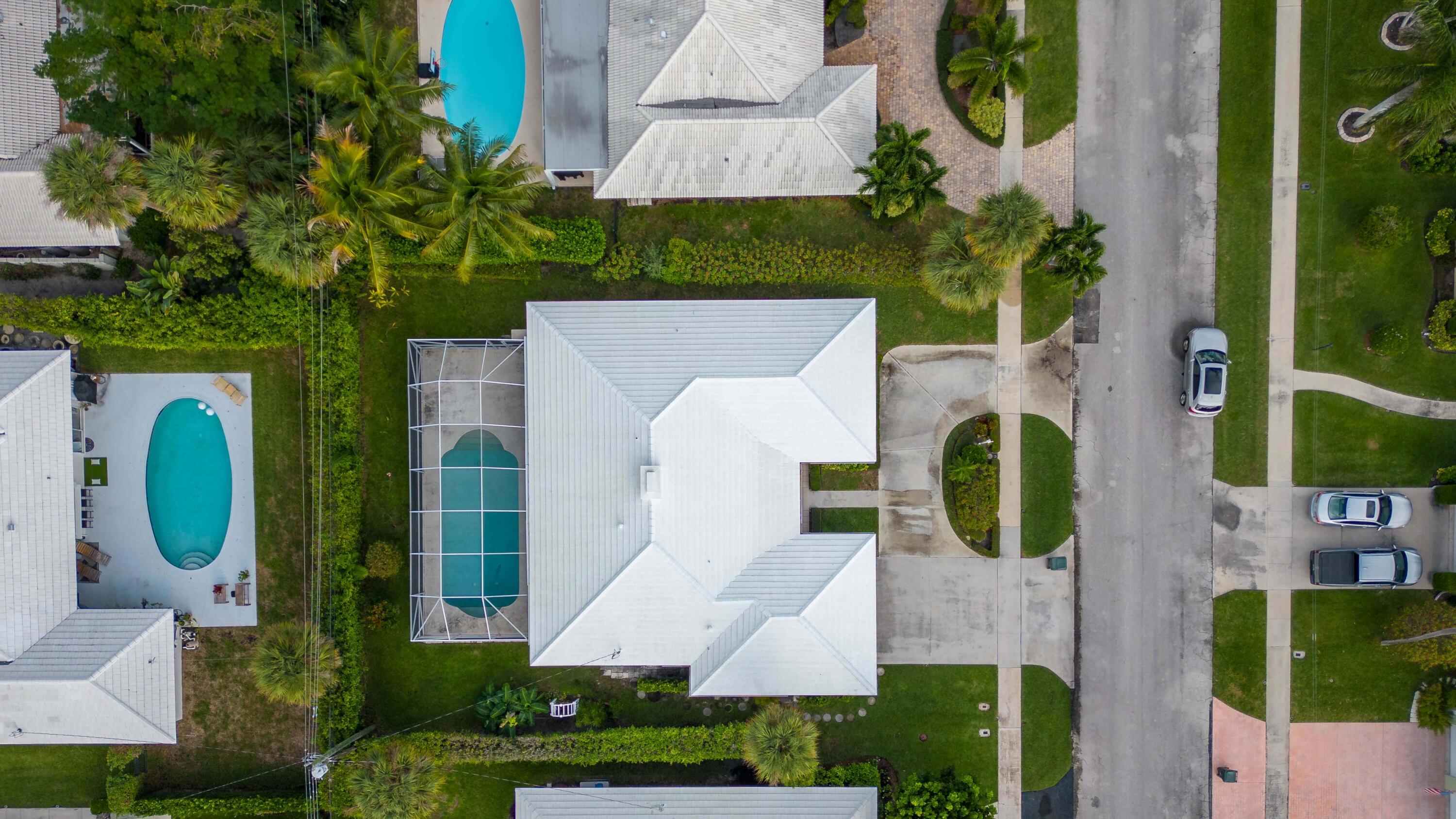 1323 Sugar Plum Drive Boca Raton, FL 33486 - Photo 24 of 28 an aerial view of a house with swimming pool and large trees