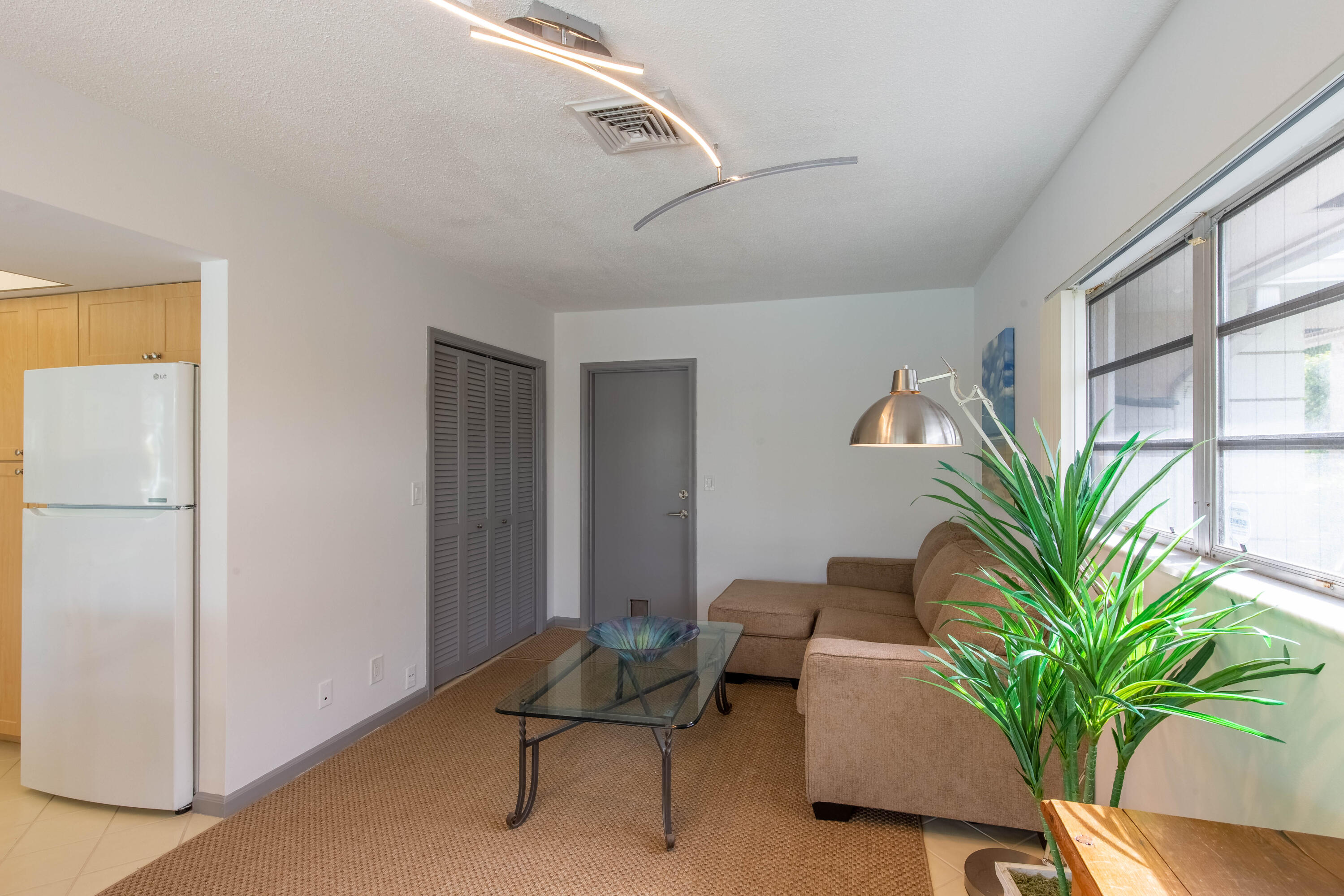 1323 Sugar Plum Drive Boca Raton, FL 33486 - Photo 8 of 28 a living room with furniture and a potted plant