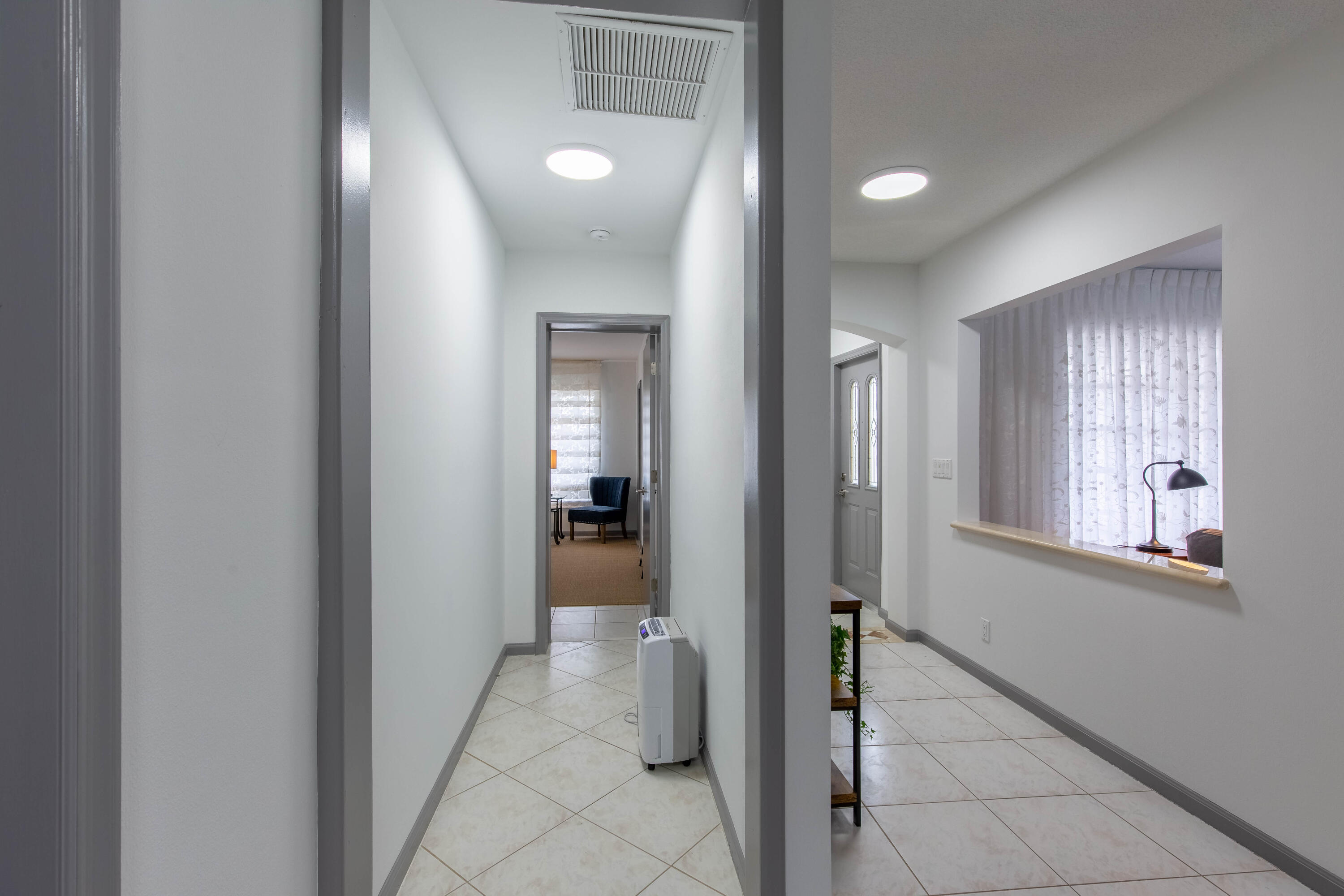 1323 Sugar Plum Drive Boca Raton, FL 33486 - Photo 10 of 28 a view of a hallway with bathroom and a glass door