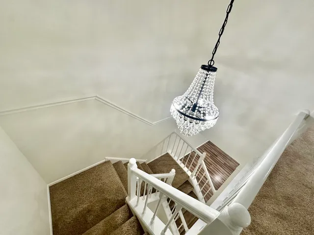 an empty room with windows and ceiling fan