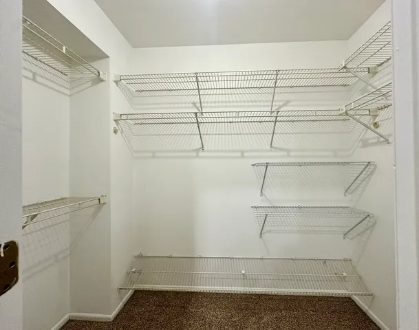 a bathroom with a granite countertop double vanity sink a mirror and a bathtub