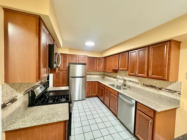 a kitchen with a stove a sink and a refrigerator