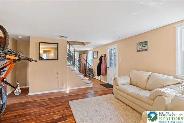 a dining room with furniture and wooden floor