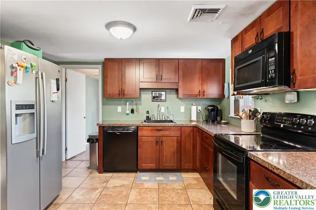 a view of a workspace with furniture and wooden floor