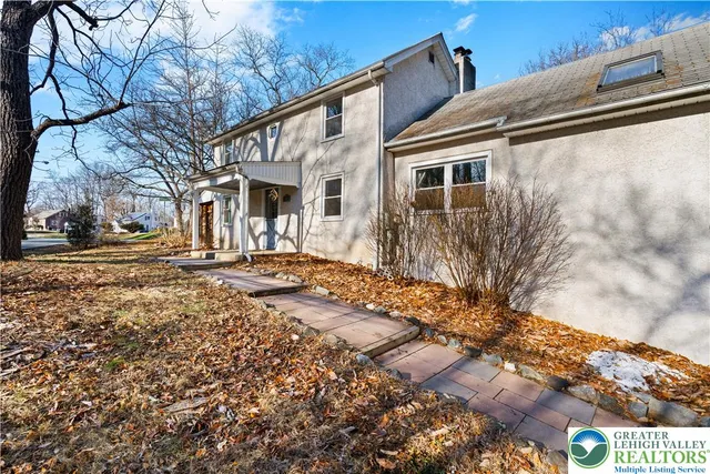 a view of a patio with table and chairs with wooden floor and fence