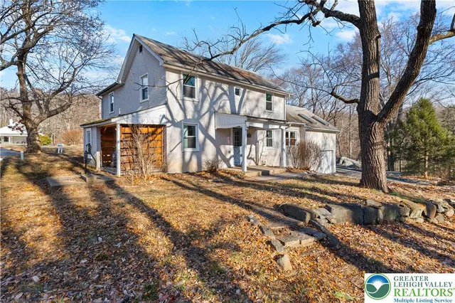 a view of a house with snow on the road
