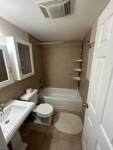 a bathroom with a sink a toilet and a bathtub
