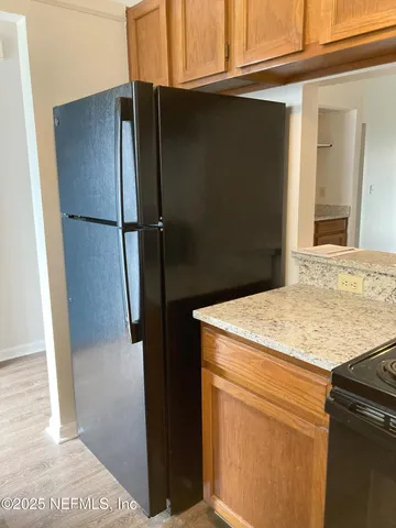 a kitchen with a refrigerator and a sink