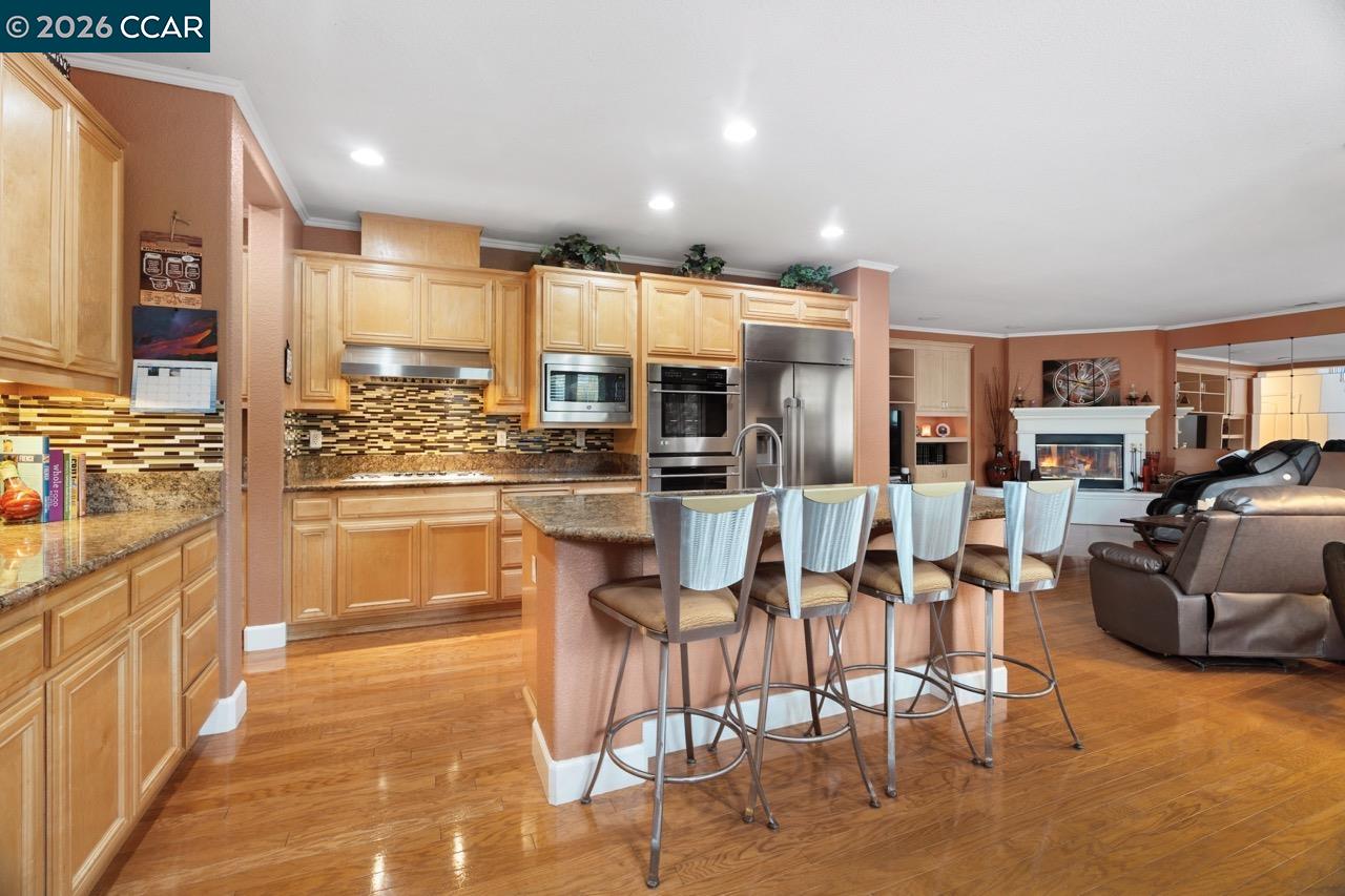 995 Rosehedge Court Concord, CA 94521 - Photo 20 of 70 a kitchen with stainless steel appliances kitchen island granite countertop a refrigerator and cabinets